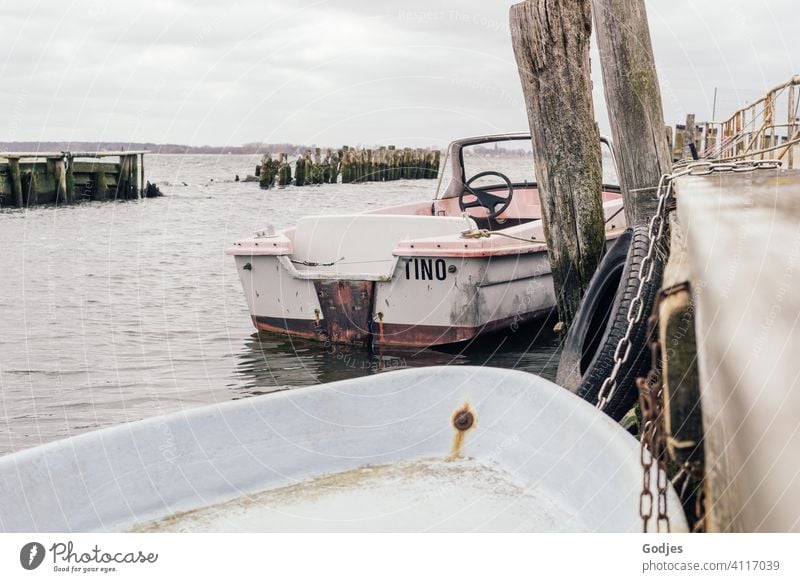 Alte verwitterte Boote an einem Holzsteg vertäut Steg Schifffahrt Wasser Meer Außenaufnahme Wasserfahrzeug Farbfoto Hafen Sommer Himmel Menschenleer