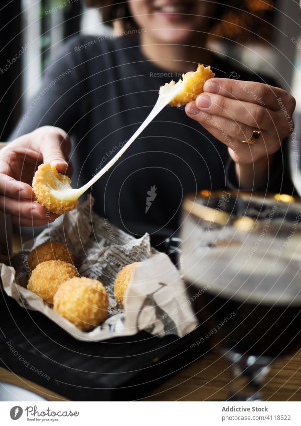 Frau isst Käsebällchen im Cafe Ball essen gebraten Snack lecker Fastfood Knusprig Café geschmackvoll besetzen Mozzarella Dehnung Mahlzeit Lächeln positiv Küche