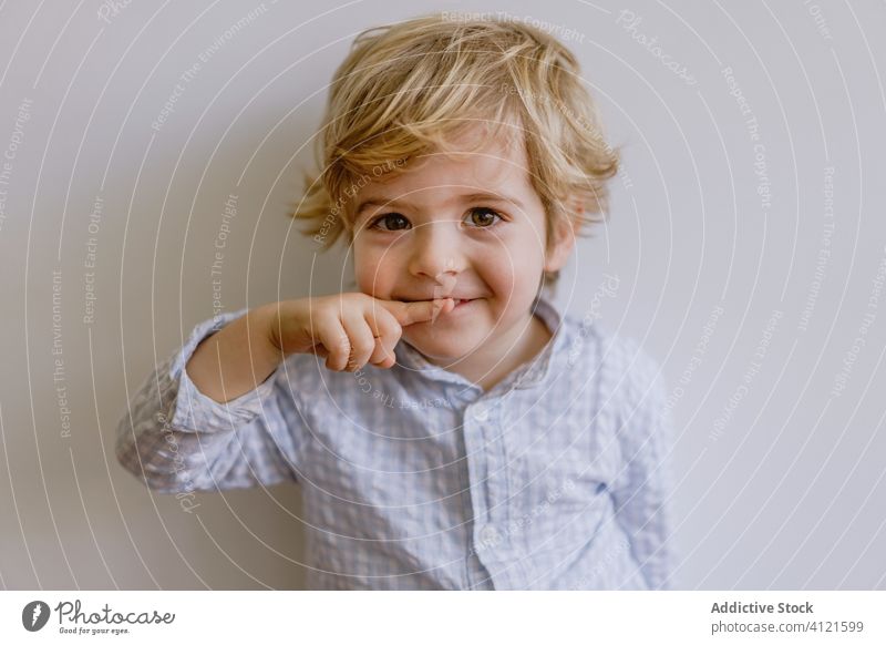 Freudig lächelnder und in die Kamera zeigender Junge Lächeln Freude wenig Kind bezaubernd Inhalt heiter Optimist niedlich Kindheit positiv lässig