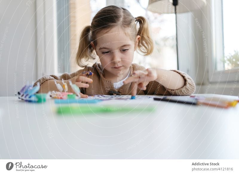 Kleines Mädchen benutzt Gouache zum Zeichnen mit den Fingern auf Papier zu Hause Zeichnung heimwärts Kind Farbe Kindergarten Kunst kreativ zeichnen niedlich