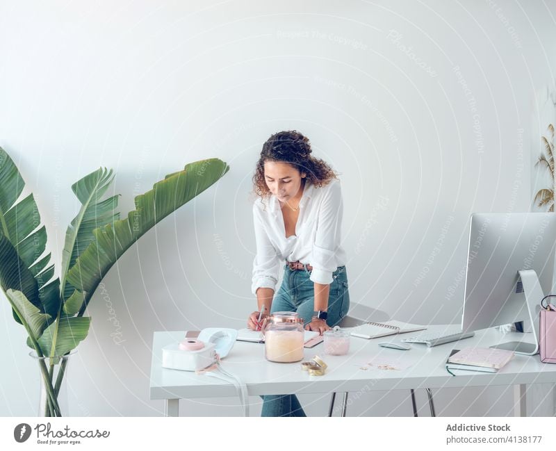 Geschäftsfrau macht Notizen im Amt Frau schreibend Notebook Büro Business Lächeln Arbeit Tisch Lehnen palma de mallorca Spanien Stil elegant Daten Design Dekor