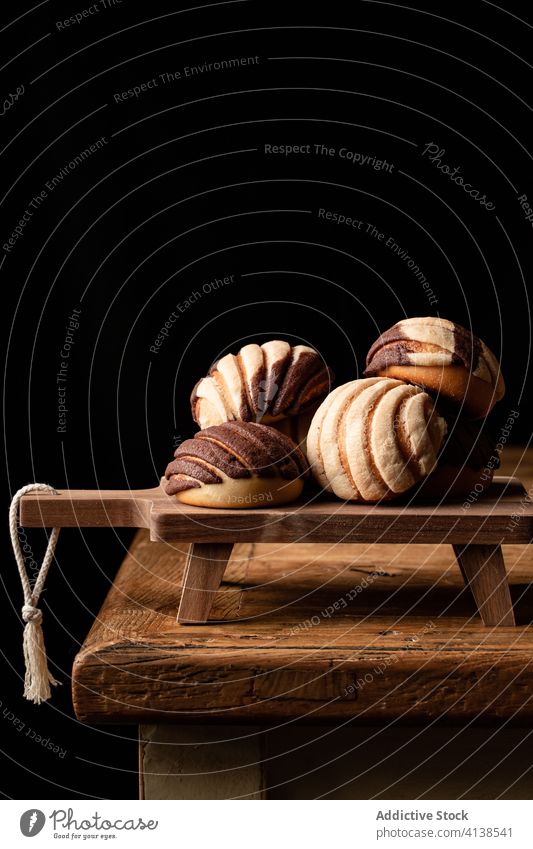 Süße mexikanische Conchas auf einem Schneidebrett Nasenmuscheln Brot Brötchen gebacken süß Dessert lecker hölzern Kultur Tradition mexikanisches Essen rollen