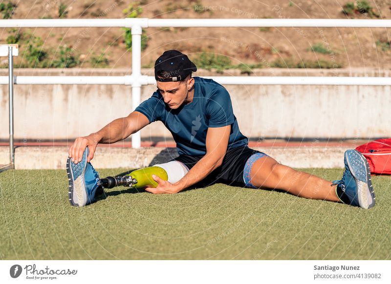 Behinderter Mann, Sportler mit Beinprothese beim Dehnen. Läufer strecken Dehnung Athlet Prothesen Prothetik Behinderung deaktiviert Amputation Amputierte