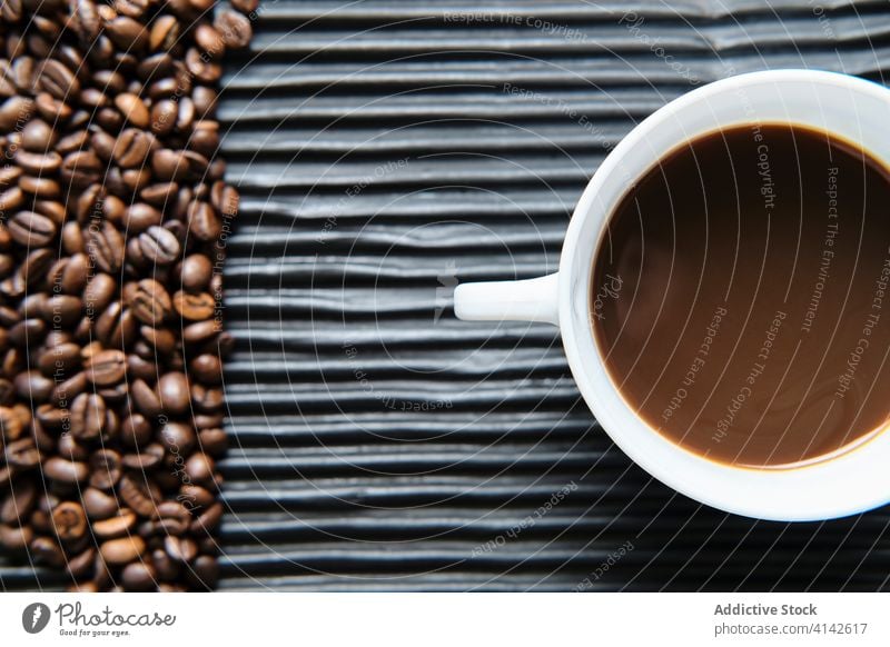 Tasse Kaffee und Kaffeekörner auf dem Tisch Bohne Tradition Kaffeemaschine Getränk trinken aromatisch Geysir frisch Koffein Aroma natürlich geschmackvoll heiß