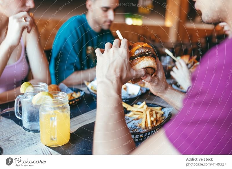 Fröhliche Freunde haben Spaß in Fast-Food-Café essen Spaß haben Fastfood heiter Glück Paar jung Zusammensein Lachen Lifestyle Freundschaft Sitzung Kommunizieren