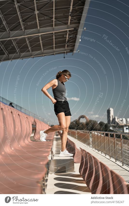 Sportliche Frau auf der Stadiontribüne Sportlerin aktiv Bestimmen Sie passen sportlich Training Fitness Übung Athlet Erholung schlank Wellness Lifestyle