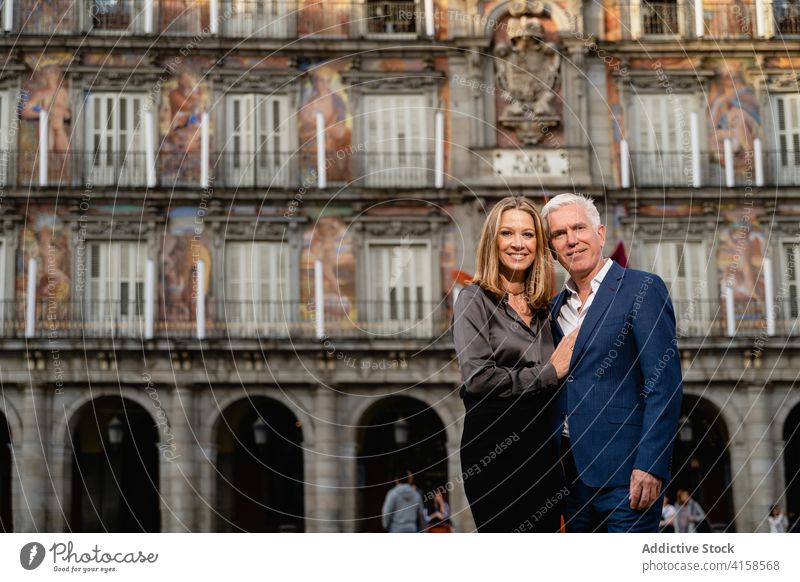 Heiteres reifes Paar in stilvollen Outfits in der Stadt elegant Stil Glück gut gekleidet Reichtum reich heiter Umarmen Mode Lebensmitte Zusammensein Lächeln