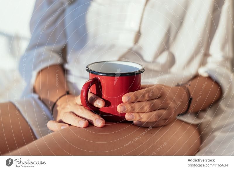 Anonyme junge Frau trinkt Kaffee im Bett trinken Morgen Glück sinnlich Komfort Verlockung gemütlich Freude weißes Hemd Körper heimwärts Getränk sonnig