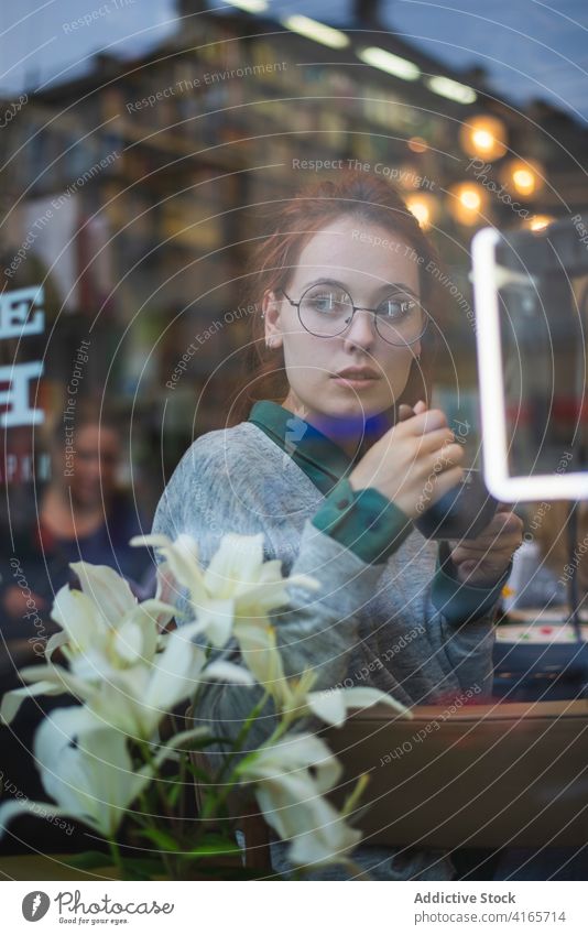 Frau trinkt Kaffee im Café mit Buch trinken genießen Literatur Leseratte Heißgetränk Getränk lässig Outfit Tisch gemütlich ruhen aromatisch Tasse sitzen jung