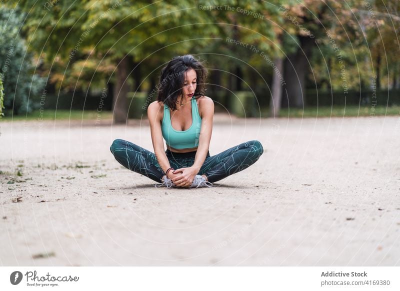 Konzentrierte Sportlerin beim Dehnen der Beine vor dem Training Aufwärmen Dehnung Frau beweglich Park Athlet Fitness Gesundheit Wellness Körper physisch