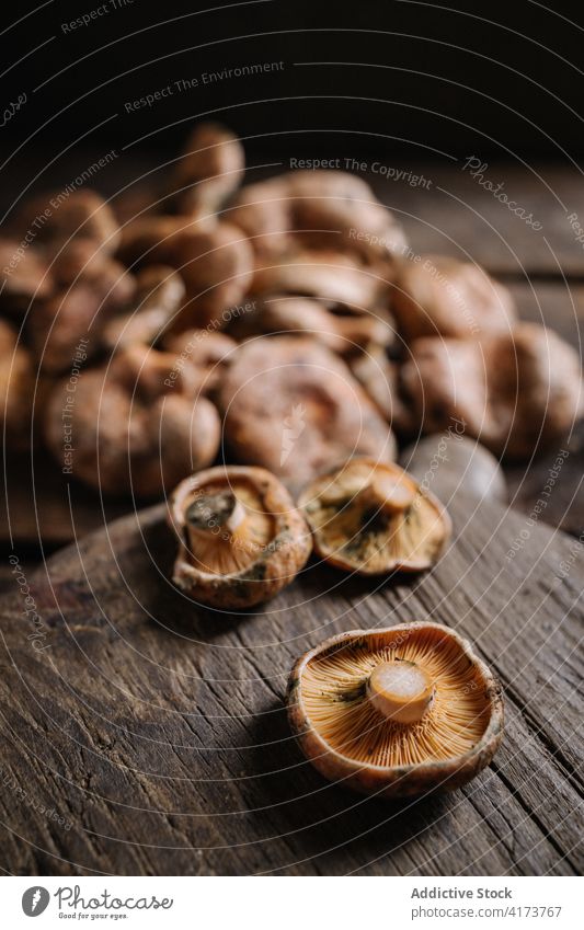 Frische Safran-Milchkappenpilze auf Holztisch Pilz Rotkiefernpilz Lactarius deliciosus Maronenröhrling wild essbar frisch roh organisch Lebensmittel natürlich