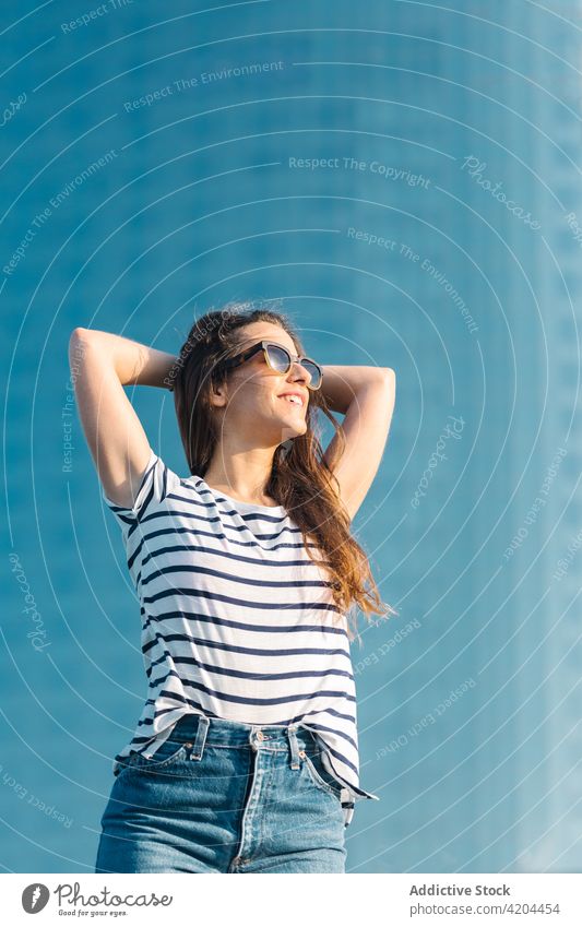 Glückliche Frau im gestreiften Hemd genießt den Sommer Stil Sonnenbrille Outfit trendy Mode sorgenfrei Streifen genießen lässig jung Brille Freude Accessoire