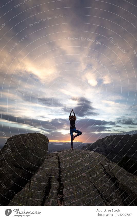 Frau in Vrksasana auf einer Bergkuppe Yoga Baum mit Armen nach oben Pose Erholung meditieren Natur beweglich selbstbewusst Berge u. Gebirge vrksasana