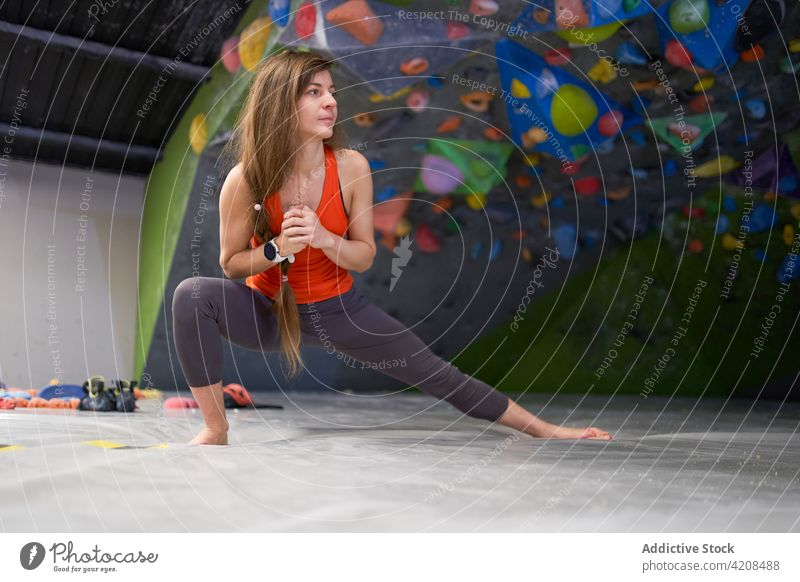 Aktive Frau streckt die Beine vor dem Training Dehnung Bouldern Bergsteiger aktiv Fokus Aufwärmen sportlich Aufsteiger stark Bestimmen Sie Konzentration