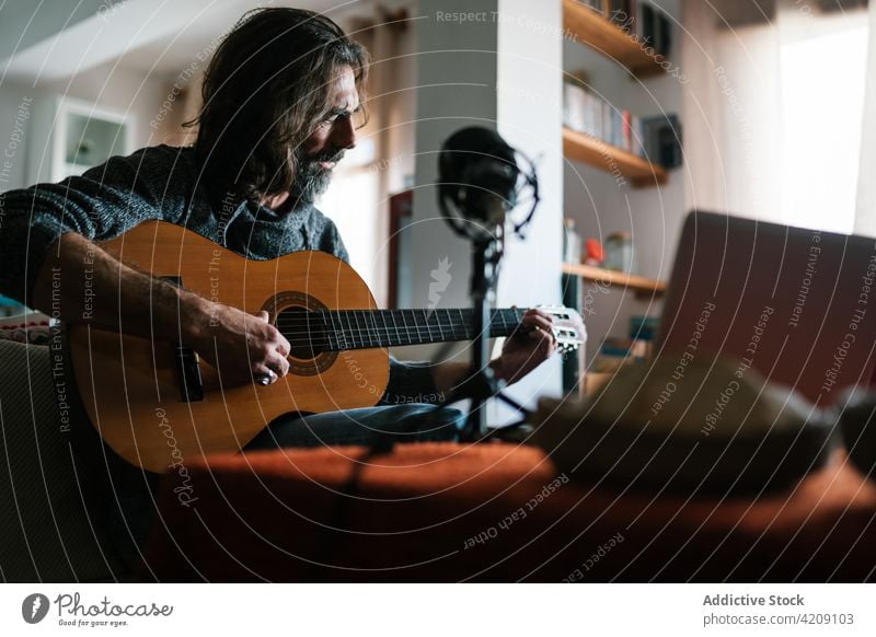 Älterer hispanischer Musiker stimmt Gitarre zu Hause Melodie akustisch Kunst Laptop Mann heimwärts ethnisch Klang Musical Instrument klassisch Netbook Stativ