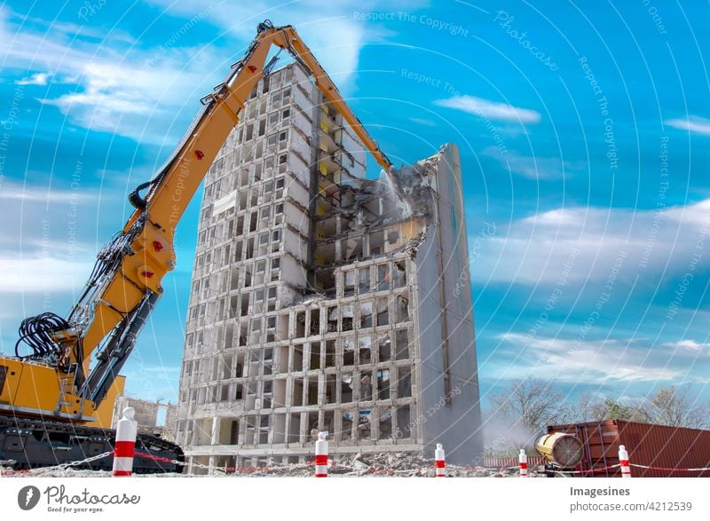 Abrisshaus. Kran wirft Wasser. Hochhausgebäude auf der Baustelle gegen blauen Wolkenhimmel. Abriss eines Hochhauses in der Innenstadt Gebäude Wohnung