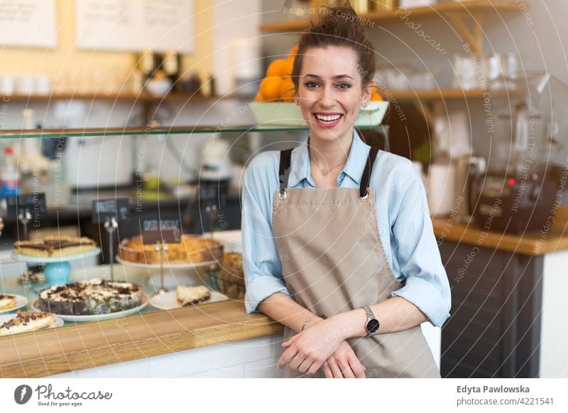 Junge Frau arbeitet in einem Café Menschen junger Erwachsener lässig attraktiv Lächeln Glück im Innenbereich Kaukasier zahnfarben genießend Restaurant Schürze