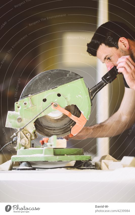 Handwerker konzentriert an der Kappsäge Heimwerker Holz aufmerksam Säge sägen Schreiner Beruf Werkzeug Arbeit & Erwerbstätigkeit Baustelle heimwerken Mann