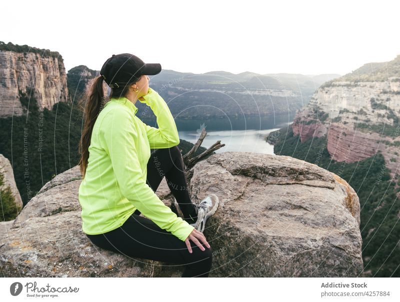 Junge Reisende, die sich auf einer Felsklippe ausruht und die Natur bewundert Frau bewundern Berge u. Gebirge ruhen genießen Erholung Wanderung Reisender