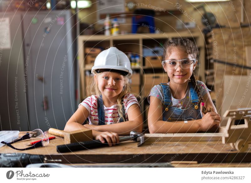 Zwei junge Mädchen bei der Holzarbeit in einer Werkstatt arbeiten Menschen Kind Kinder Frauenpower Fähigkeit Handwerk Garage Hobby Lifestyle Werkzeuge