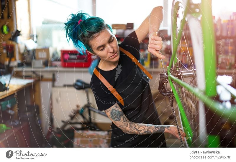 Junge Frau arbeitet in einer Fahrradwerkstatt Vertriebsmitarbeiter Fahrradmechaniker Radfahren Fahrradladen Business Einzelhandel Zyklus hilfreich