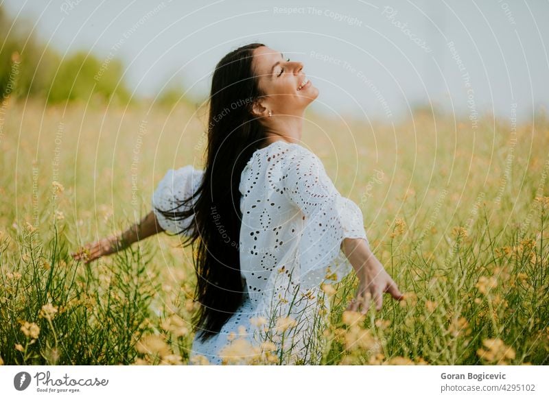 Junge Frau auf dem Rapsfeld schön Feld außerhalb gelb Sommer im Freien Schönheit Glück Frühling Person Wiese Natur Blume Freiheit Lifestyle sonnig geblümt