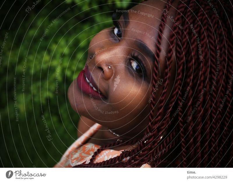 Gené • Frau mit Braids und freundlichem Blick über die Schulter frau weiblich portrait feminin schmuck blick frisur ohrring nahaufnahme lächeln halbprofil