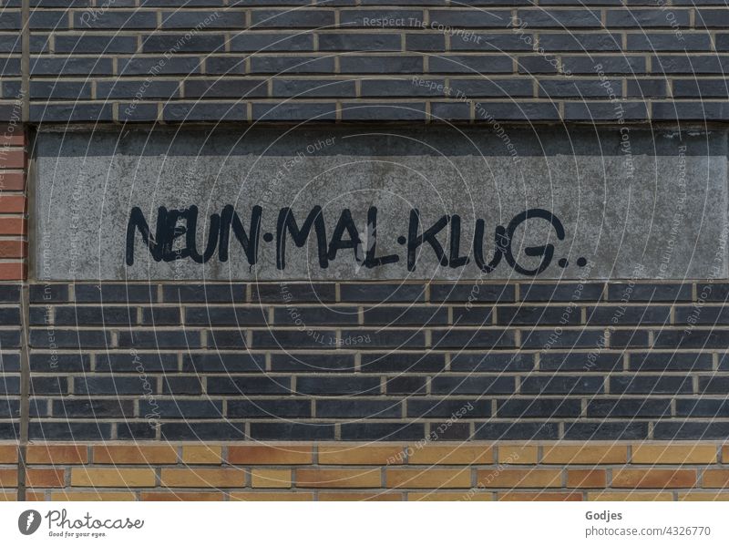 NeunMalKlug Schriftzug an der Wand eines Universitätsgebäudes Graffiti Schriftzeichen Mauer Außenaufnahme Textfreiraum oben Textfreiraum unten