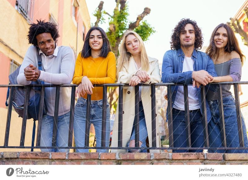 Multirassische Gruppe von jungen Leuten, die sich auf der Straße unterhalten. Menschengruppe Schüler multiethnisch sozialisierend Vielfalt Freunde