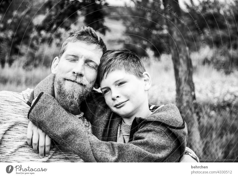 vater mit dem sohn. kuschelnde zufriedenheit. mit liebe glücklich. Geborgenheit Fröhlichkeit lachen Vertrauen Kindheit Schwarzweißfoto Vater Sohn Liebe