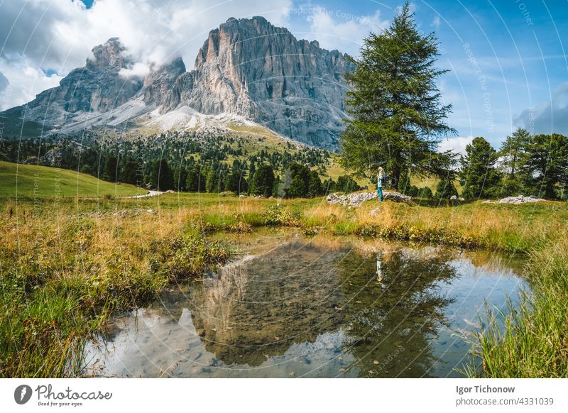 Frau beim Wandern im Grödnertal. Teich und Reflexion von Langkofel Berg Sassolungo. Dolomiten, Italien Sommer Landschaft Gröden sassolungo val alpin Alpen