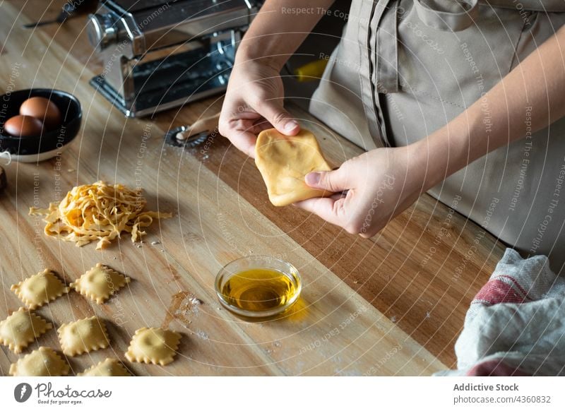 Anonyme Person bei der Zubereitung von hausgemachten Raviolis Lebensmittel Essen zubereiten Gesundheit Tisch traditionell hölzern Ernährung Nahaufnahme Spätzle