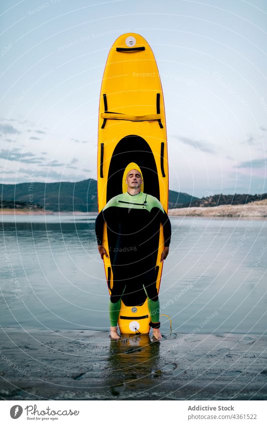 Surfer mit Paddleboard am Meer Paddelbrett Mann Strand Zusatzplatine Meeresufer Neoprenanzug Surfbrett MEER männlich Sport Wasser Sommer Surfen Küste Seeküste