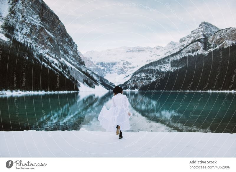 Unbekannte Frau läuft im Winter auf einen See zu laufen Ufer Berge u. Gebirge Natur Schnee kalt reisen Lake Luise Banff National Park Alberta Kanada Wasser