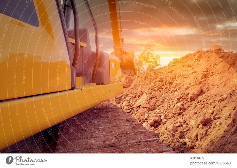 Rückansicht eines Baggers, der auf einer Baustelle Erde aushebt. Raupenbagger beim Graben auf einer Abbruchbaustelle. Aushubmaschine. Erdbewegungsmaschine. Aushubfahrzeug. Baugeschäft.