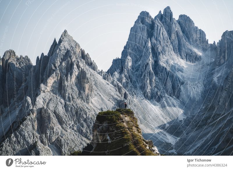 Ein Wanderer steht und bewundert die atemberaubende Schönheit der beeindruckenden zerklüfteten Gipfel der Cadini di misurina Berggruppe in den Dolomiten, Italien, Teil des Nationalparks Tre Cime di Levaredo