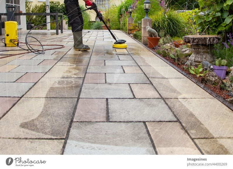 Frühjahrsputz. Terrassenplatten mit dem Hochdruckreiniger reinigen. Arbeiter Gummistiefel Boden im Freien reinigung Erwachsener Gebäude Geschäft sauber Reiniger