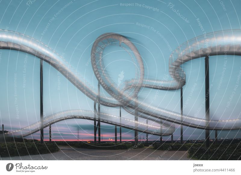 Kunstwerk gebogene Stahltreppe vor Abendhimmel, Langzeitbelichtung kunstwerk Treppe Metall Bogen kurvig Tiger and Turtle Magic Mountain rund Wahrzeichen