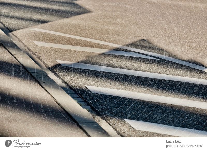 Schatten, Linien und Kontraste: Farbmarkierung, Randstein und Schatten von Gebäuden ergeben das Bild Sonnenlicht Sonnenschein hell grell Sommer