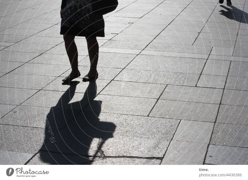 unterwegs silhouette schatten urban frau sonnig betonplatten bodenbelag platz querung gegenlicht