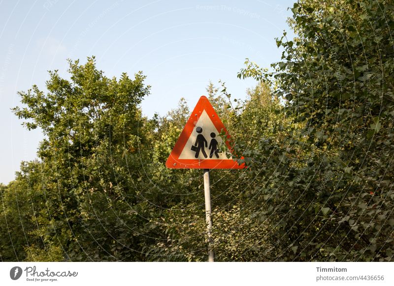 Vorsicht! Kofferträger mit Nachwuchs Schilder & Markierungen Strassenschild Symbole & Metaphern Fußgänger Straße Wege & Pfade Gebüsch Himmel schönes Wetter