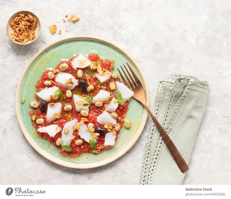 Sommerlicher Salat aus Tomaten und Kabeljau farbenfroh Minzblätter Minze Gemüse Draufsicht Portion Fava-Bohne nahrhaft natürlich produzieren niemand