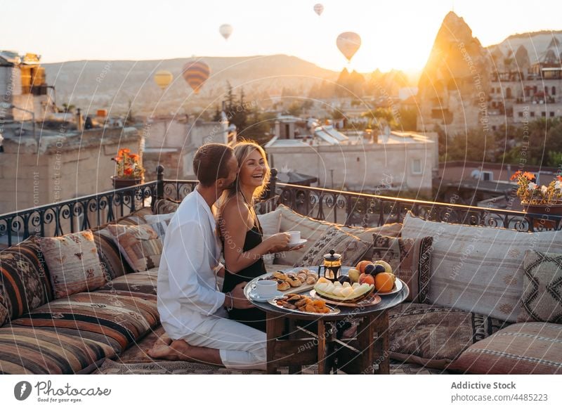 Mann küsst Frau auf dem Dach während eines Dates Paar Kuss Liebe Terrasse romantisch Dessert Zusammensein Bonden Tee Partnerschaft genießen Angebot Zuneigung