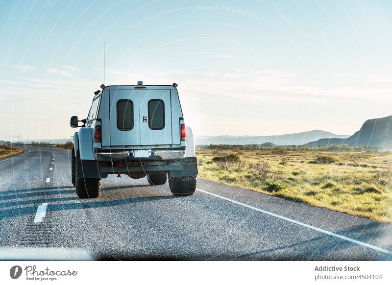 SUV-Auto auf asphaltierter Straße auf dem Lande PKW Landschaft Asphalt wolkenlos suv Offroad Fahrzeug modern Verkehr Umwelt Laufwerk tagsüber Sonne leer