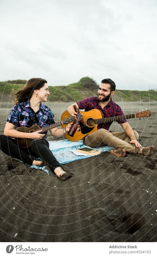 Musikfreunde trinken tagsüber Bier am Meeresstrand Paar Musiker Freund Strand Klirren MEER Alkohol Gitarre Frau Mann Ukulele positiv Flasche Meeresufer Ufer