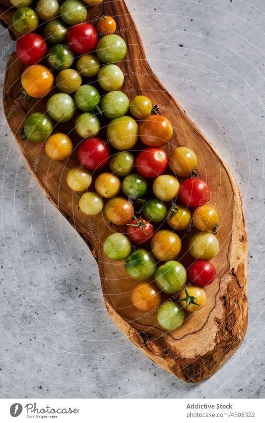 Kleine, gesunde Kirschtomaten auf einem Holzbrett Ackerbau Ernte unreif Gemüse heilsam Agronomie Lebensmittel viele Saison kultivieren Gesundheit Landschaft