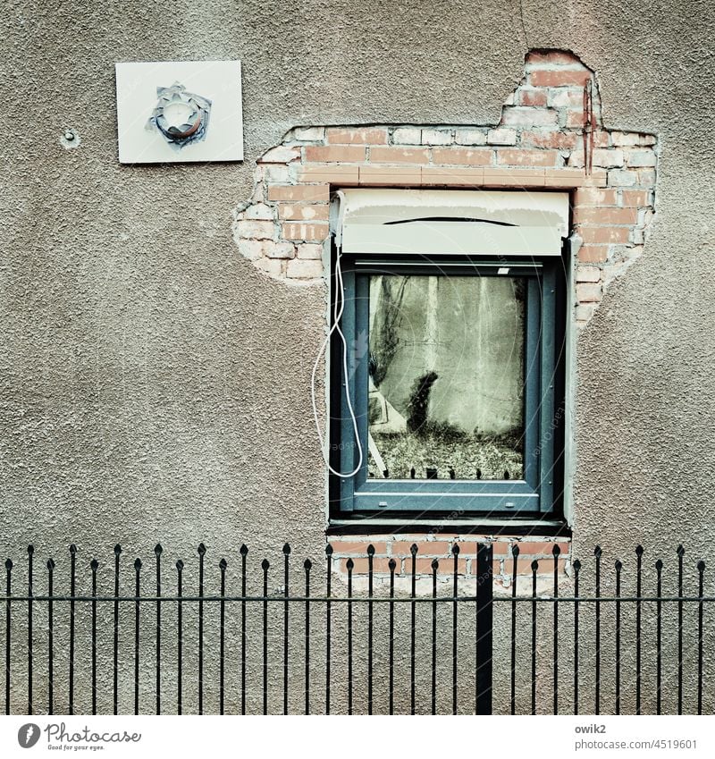 Halbgar Fenster Haus Wand Totale eingebaut provisorisch vorläufig halbfertig unvollendet Backsteinwand verputzt lückenhaft Fensterrahmen Zaun Gitter Metall