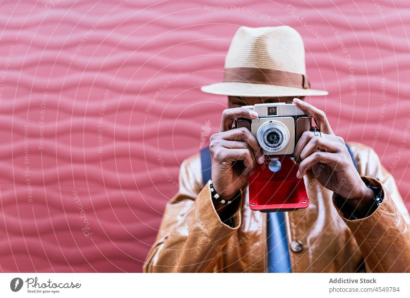 Anonymer Mann fotografiert auf dem Fahrrad Wand Straße Zeitvertreib Hobby Fotoapparat fotografieren Fotografie einfangen Gedächtnis Gerät Laufsteg Streetstyle