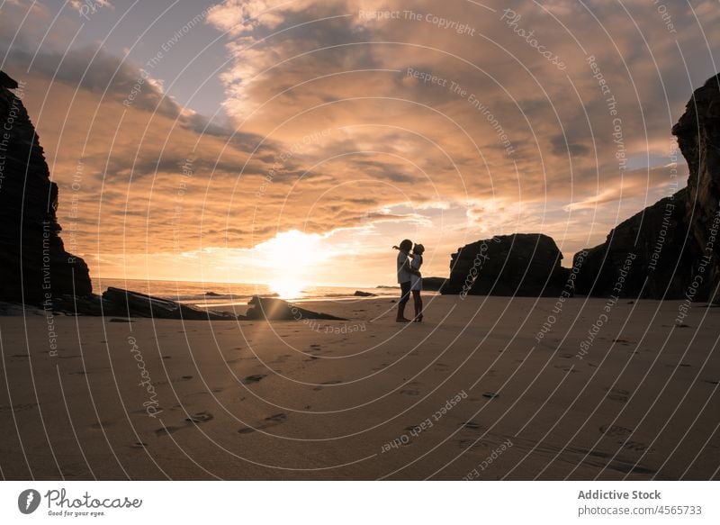 Paar am Strand stehend am Abend Silhouette Umarmen Sonnenuntergang Umarmung Zusammensein Dämmerung Ufer malerisch Spaziergang Strand der Kathedralen Galicia