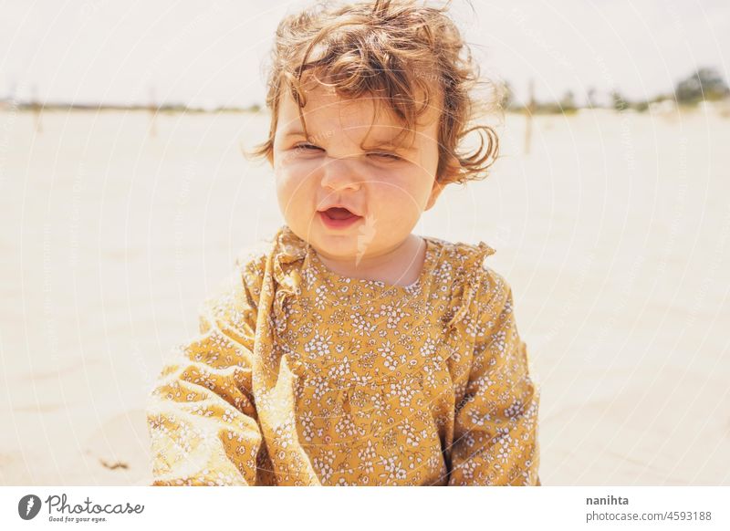 Kleines Mädchen spielt mit Sand am Strand Baby Mutterschaft Urlaub Feiertage im Freien Sonne Kind Kleinkind genießen Freude warm Spaß lustig Porträt sonnig